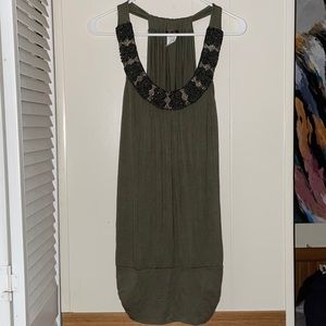 Green top for ladies with beads around the collar. Size L